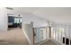 Bright upper hallway with white railings, leading to a bedroom, providing an open and airy transition space at 4034 E Mine Shaft Rd, San Tan Valley, AZ 85143