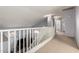 This bright upper hallway, with white railings, showcases a view to the lower level, creating an open, airy atmosphere at 4034 E Mine Shaft Rd, San Tan Valley, AZ 85143