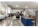 Well-lit kitchen showcases stainless steel appliances, an island with seating, and ample counter space at 4034 E Mine Shaft Rd, San Tan Valley, AZ 85143