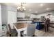 Bright kitchen with white cabinets, stainless steel appliances, and a stylish chandelier at 4034 E Mine Shaft Rd, San Tan Valley, AZ 85143