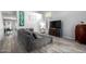 Cozy living room featuring a plush gray sectional and stylish furnishings at 4034 E Mine Shaft Rd, San Tan Valley, AZ 85143