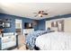 Bright main bedroom featuring blue walls, a ceiling fan, and an ensuite bathroom at 4034 E Mine Shaft Rd, San Tan Valley, AZ 85143