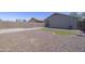 Spacious backyard with rock landscaping and artificial turf at 41388 W Hopper Dr, Maricopa, AZ 85138