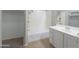 Well-lit bathroom with a shower-tub combo and a vanity with a single sink at 41388 W Hopper Dr, Maricopa, AZ 85138