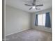 Bedroom featuring carpet, ceiling fan and natural light streaming through the window at 41388 W Hopper Dr, Maricopa, AZ 85138