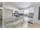 Bright kitchen featuring stainless steel appliances, granite countertops, and a stylish backsplash at 41388 W Hopper Dr, Maricopa, AZ 85138