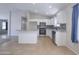 Modern kitchen with stainless steel appliances, white cabinets, tile backsplash, and tile floors at 41388 W Hopper Dr, Maricopa, AZ 85138