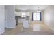 Bright and airy kitchen featuring modern appliances and breakfast nook with blue curtains at 41388 W Hopper Dr, Maricopa, AZ 85138