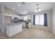Well-lit kitchen with stainless steel appliances and tiled floors adjacent to the breakfast nook at 41388 W Hopper Dr, Maricopa, AZ 85138
