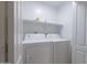 Laundry room featuring a side-by-side washer and dryer and shelving at 41388 W Hopper Dr, Maricopa, AZ 85138