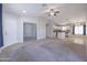 Expansive living room showing the kitchen, adjacent bedroom and front door at 41388 W Hopper Dr, Maricopa, AZ 85138
