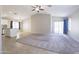 Open living room showcasing a neutral color palette and easy access to the kitchen and backyard at 41388 W Hopper Dr, Maricopa, AZ 85138