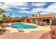 Relaxing backyard featuring a sparkling pool, lush landscaping, and a cozy patio area at 4245 E Yawepe St, Phoenix, AZ 85044