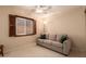 Well-lit bedroom featuring a sofa and ceiling fan for added comfort at 4245 E Yawepe St, Phoenix, AZ 85044