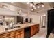 Open concept kitchen with tile countertops and wood cabinets flows into a comfortable living space at 4245 E Yawepe St, Phoenix, AZ 85044