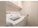 Bright laundry room featuring a modern washer and dryer with plenty of storage space at 4245 E Yawepe St, Phoenix, AZ 85044