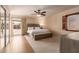 Bright main bedroom featuring a ceiling fan, natural light and a private patio entrance at 4245 E Yawepe St, Phoenix, AZ 85044