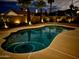 Backyard pool at night with landscape lighting, offering a peaceful ambiance and mountain views at 4245 E Yawepe St, Phoenix, AZ 85044