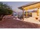 Picturesque backyard featuring a pool, covered patio, and lush landscaping at 4282 N 180Th Dr, Goodyear, AZ 85395