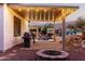 Inviting backyard with string lights, pool, patio, and outdoor kitchen area at 4282 N 180Th Dr, Goodyear, AZ 85395