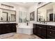 The primary bathroom features dual vanities and a soaking tub at 4282 N 180Th Dr, Goodyear, AZ 85395