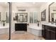 Bathroom with dual vanities and soaking tub with natural light at 4282 N 180Th Dr, Goodyear, AZ 85395