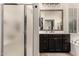 Well-lit bathroom featuring a vanity and glass-enclosed shower at 4282 N 180Th Dr, Goodyear, AZ 85395