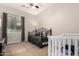 Comfortable bedroom with a daybed, crib and a ceiling fan at 4282 N 180Th Dr, Goodyear, AZ 85395