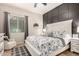 Comfortable bedroom with modern decor, gray accent wall, plush patterned bedding and natural light at 4282 N 180Th Dr, Goodyear, AZ 85395
