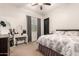 Well-lit bedroom with a comfortable bed, vanity table, and a ceiling fan at 4282 N 180Th Dr, Goodyear, AZ 85395