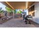 Covered patio with a built-in grill, storage area, desert landscaping, and access to the pool at 4282 N 180Th Dr, Goodyear, AZ 85395