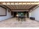 Outdoor patio dining area with a pergola, lighting, outdoor art, and view of the backyard at 4282 N 180Th Dr, Goodyear, AZ 85395