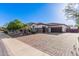 A charming single-story home with a three-car garage and a brick-paved driveway at 4282 N 180Th Dr, Goodyear, AZ 85395