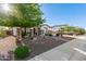 Charming single-story home featuring decorative rock landscaping and mature trees in the front yard at 4282 N 180Th Dr, Goodyear, AZ 85395
