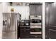 Modern kitchen with stainless steel appliances and mixed white and gray cabinets at 4282 N 180Th Dr, Goodyear, AZ 85395