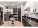 Modern kitchen with stainless steel appliances, sleek countertops, and black and white cabinets at 4282 N 180Th Dr, Goodyear, AZ 85395