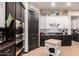 Stylish kitchen featuring modern appliances, dual-tone cabinets, and tile backsplash for a contemporary look at 4282 N 180Th Dr, Goodyear, AZ 85395