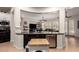 Open floor plan kitchen featuring dark cabinets, granite counters, and easy access to the living room at 4282 N 180Th Dr, Goodyear, AZ 85395