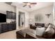 Comfortable living room with a leather sectional sofa and a built-in entertainment center at 4282 N 180Th Dr, Goodyear, AZ 85395