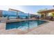 Beautiful backyard pool with water feature, lounge chairs, basketball hoop, and covered patio at 4282 N 180Th Dr, Goodyear, AZ 85395