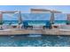 Close up view of the elegant water feature, in the pool, with desert themed mural backdrop and lounge seating at 4282 N 180Th Dr, Goodyear, AZ 85395