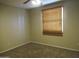 Cozy bedroom featuring neutral carpeting and a window with wood blinds at 430 W Santa Cruz Dr, Tempe, AZ 85282