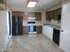 Kitchen features a range, refrigerator, wood cabinets and tile flooring at 430 W Santa Cruz Dr, Tempe, AZ 85282
