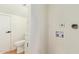 Hallway with a half bath and access to laundry with fixtures for washer and dryer hookups at 4317 W Orangewood Ave, Glendale, AZ 85301