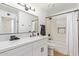 Modern bathroom features a sleek vanity with a large mirror and a shower-tub combo with a curtain at 4317 W Orangewood Ave, Glendale, AZ 85301