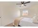 Well-lit bedroom with a plush queen bed, ceiling fan, and a window creating an inviting atmosphere at 4317 W Orangewood Ave, Glendale, AZ 85301