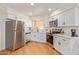 Modern kitchen featuring stainless steel appliances, bright cabinets, and ample counter space at 4317 W Orangewood Ave, Glendale, AZ 85301