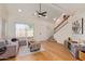 Bright living room featuring a ceiling fan, wood floors, and an open floor plan at 4317 W Orangewood Ave, Glendale, AZ 85301