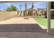 Large backyard features paver patio, artificial turf, and a fire pit, perfect for entertaining at 4626 E Villa Rita Dr, Phoenix, AZ 85032