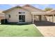 Backyard features artificial turf, a paver patio and covered patio accessible by sliding glass doors at 4626 E Villa Rita Dr, Phoenix, AZ 85032